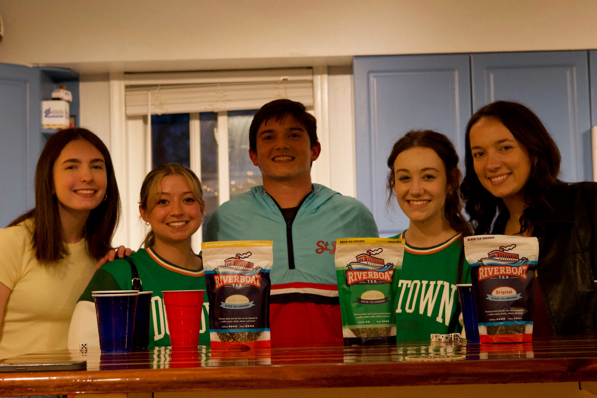 Group of Friends Posed behind Riverboat Tea