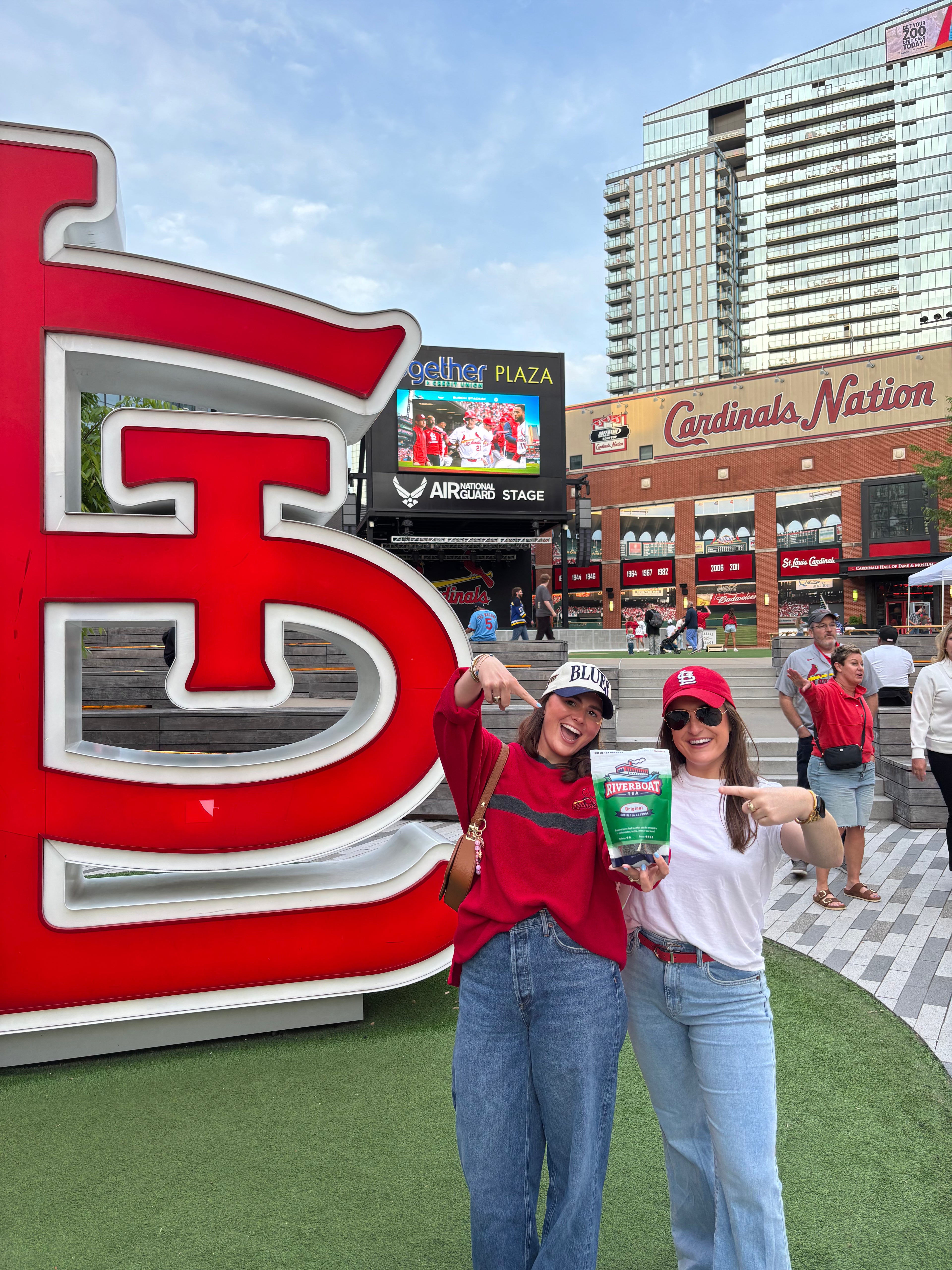People Holding Riverboat Tea Outside Busch Stadium