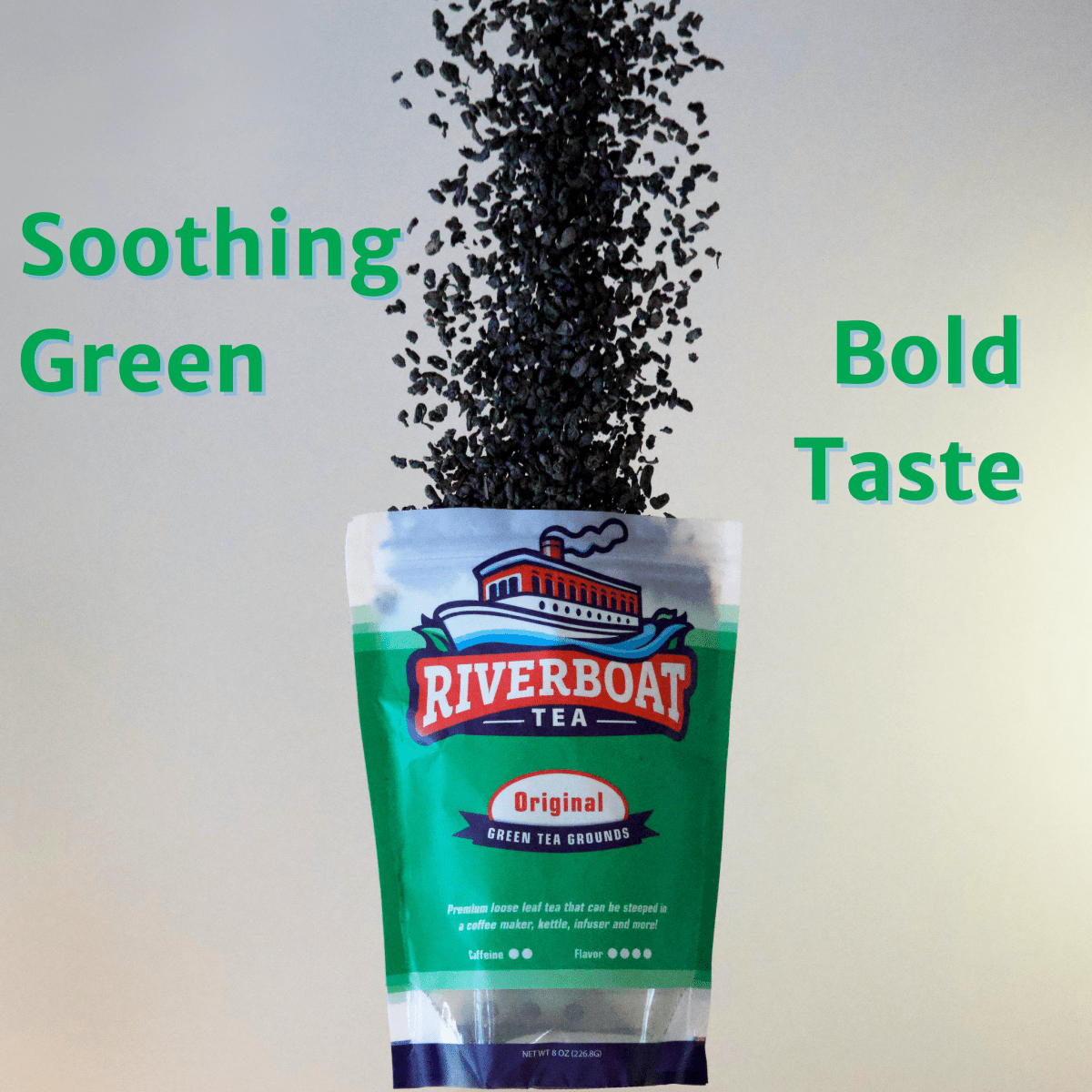 Riverboat Tea package with tea leaves spilling out, labeled 'Soothing Green' and 'Bold Taste'.